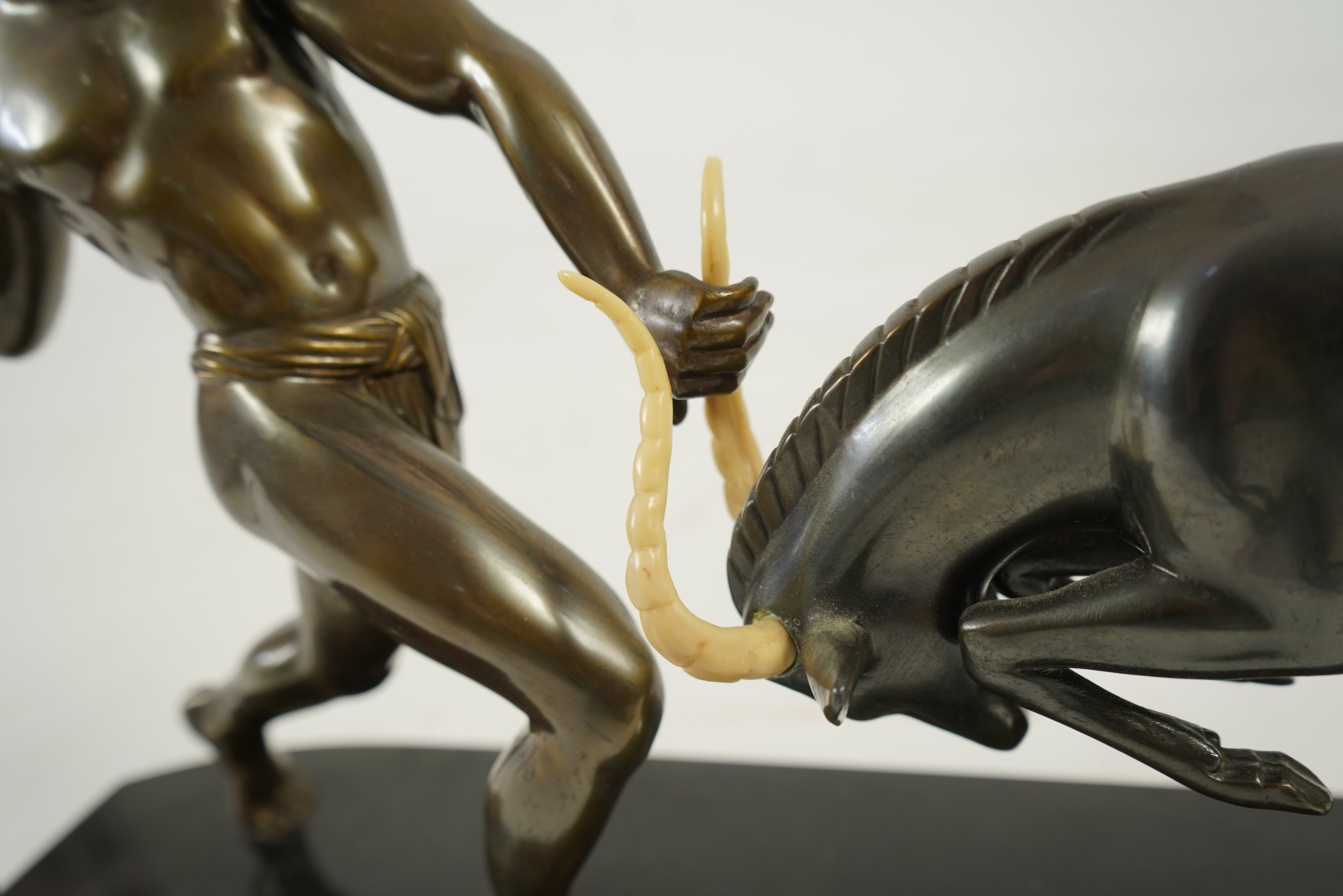 Attributed to Zoltan Kovasz (Romanian, 1883-1952), a bronzed spelter male hunter holding a chromed spear, with springbok, on a polished slate base